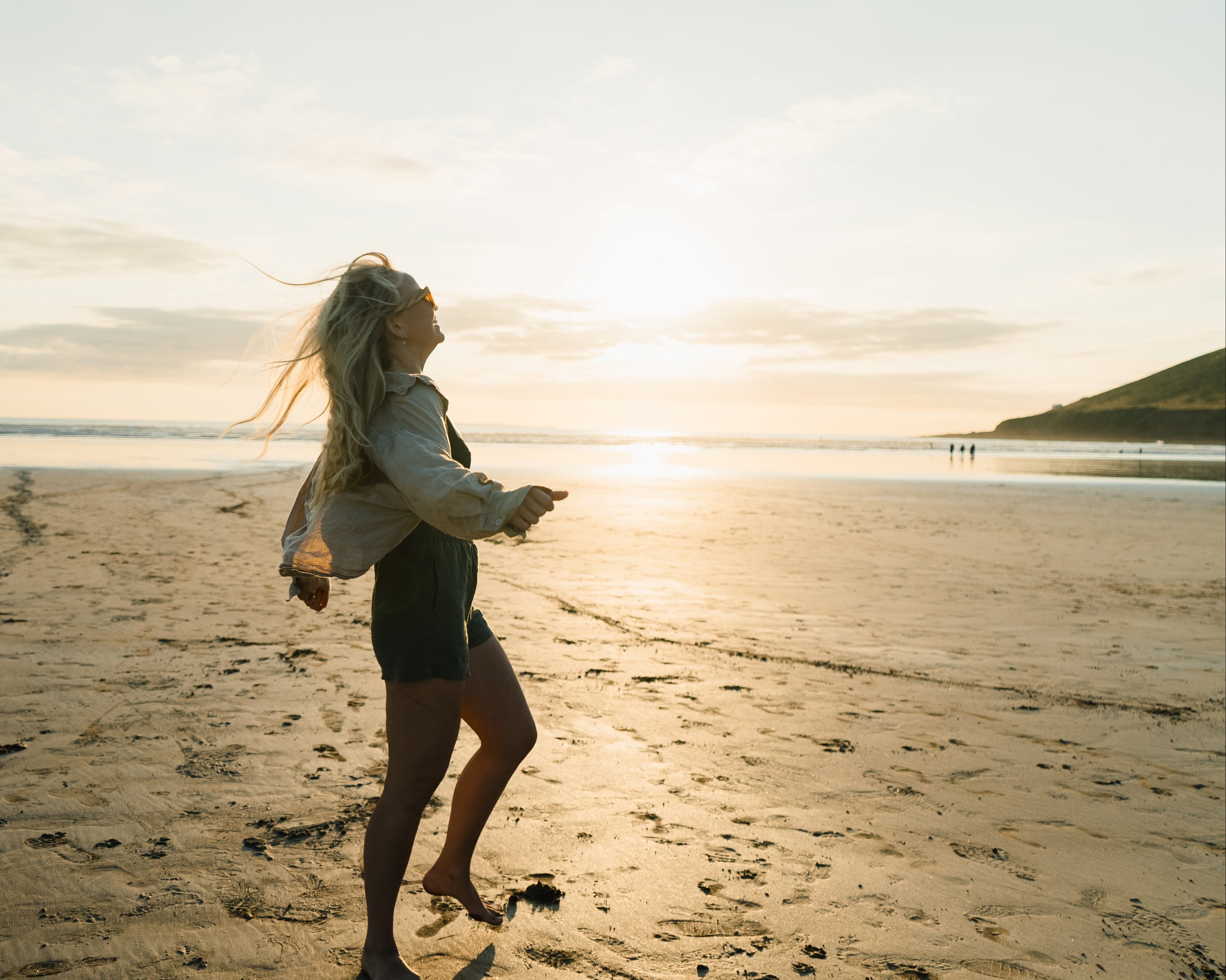 Women walking on cornwall beach at sunset