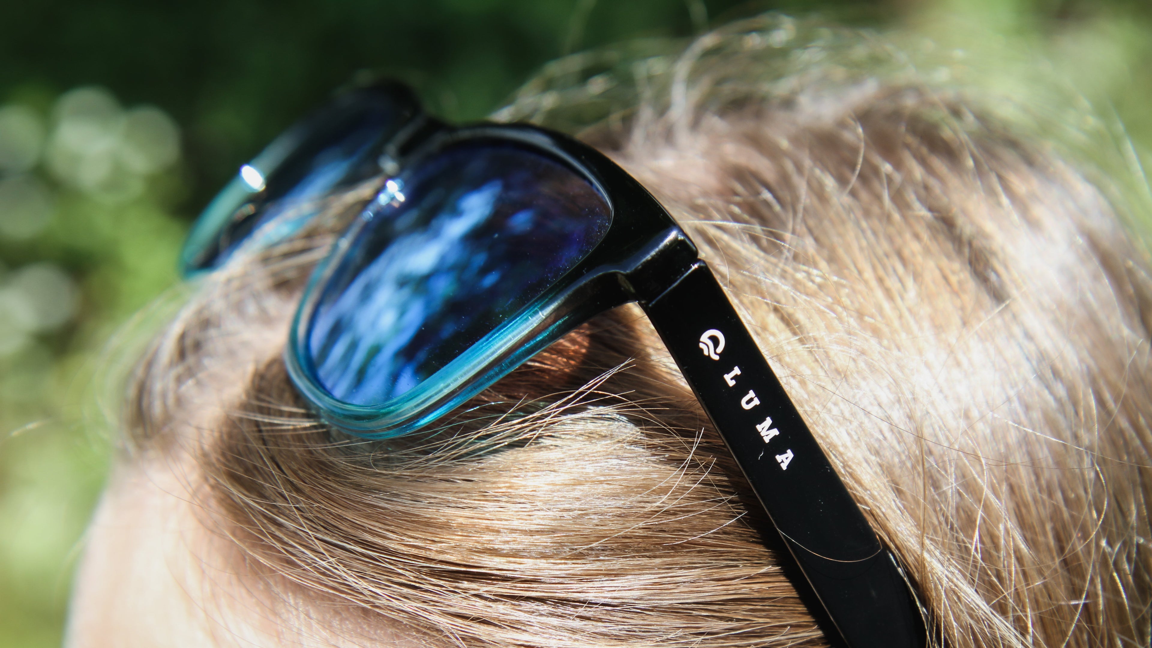 harlyn blue black sunglasses on womans head closeup