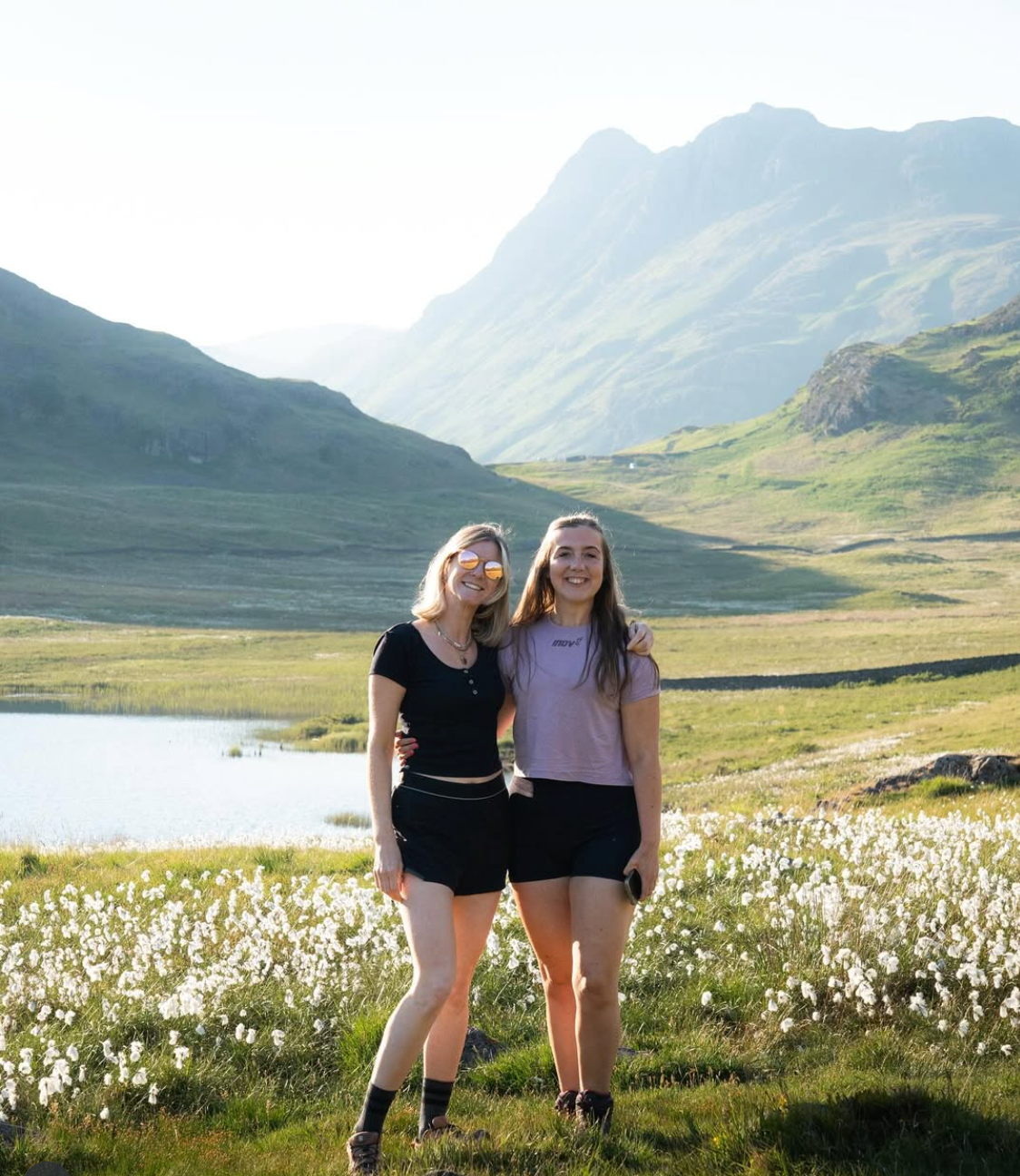 two ladies standing together infront of lake district views