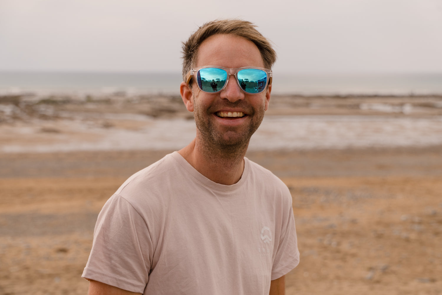 Will Harrison founder of Luma Eyewear on beach smiling