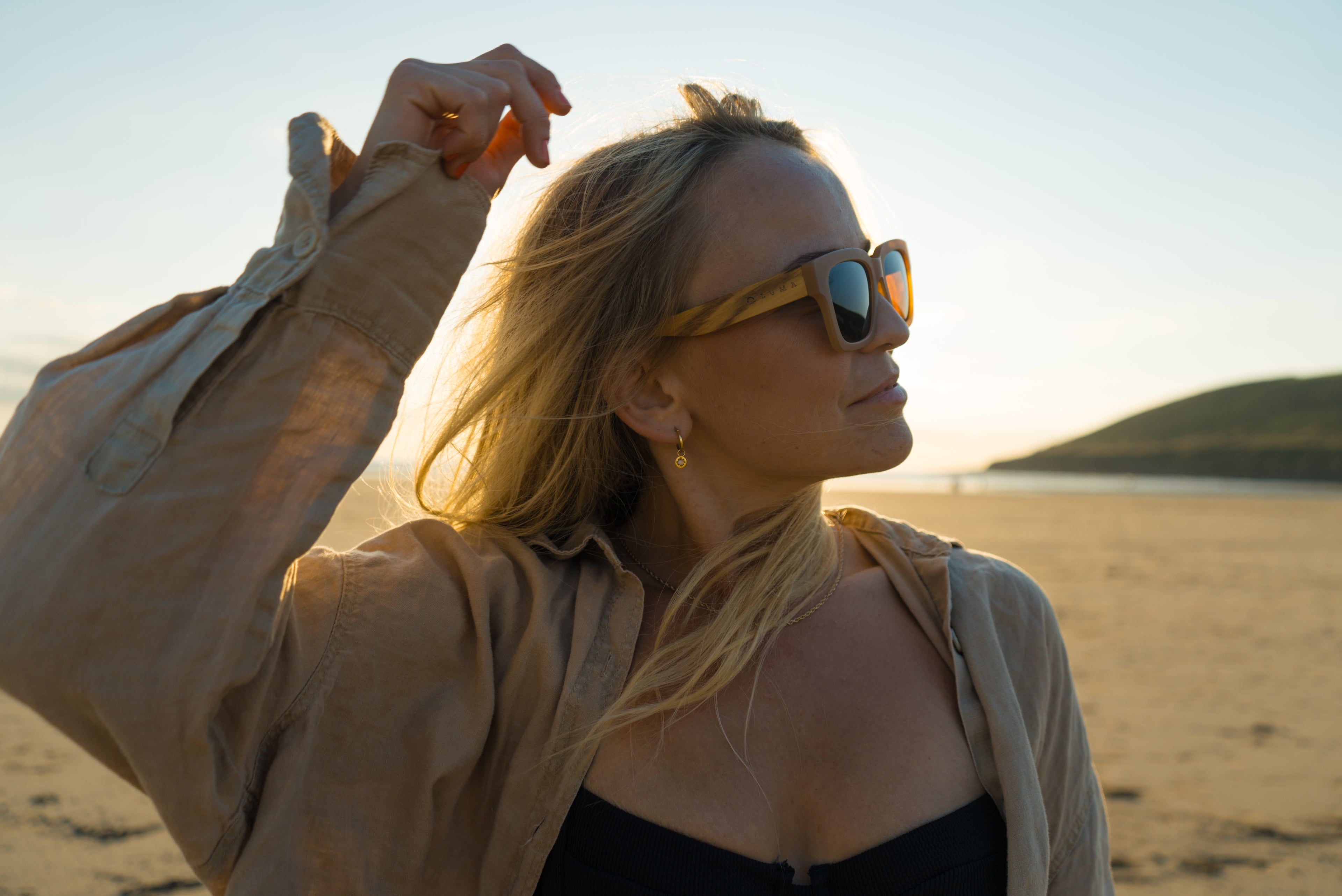 Eco-friendly sunglasses on lady on a beach in Cornwall