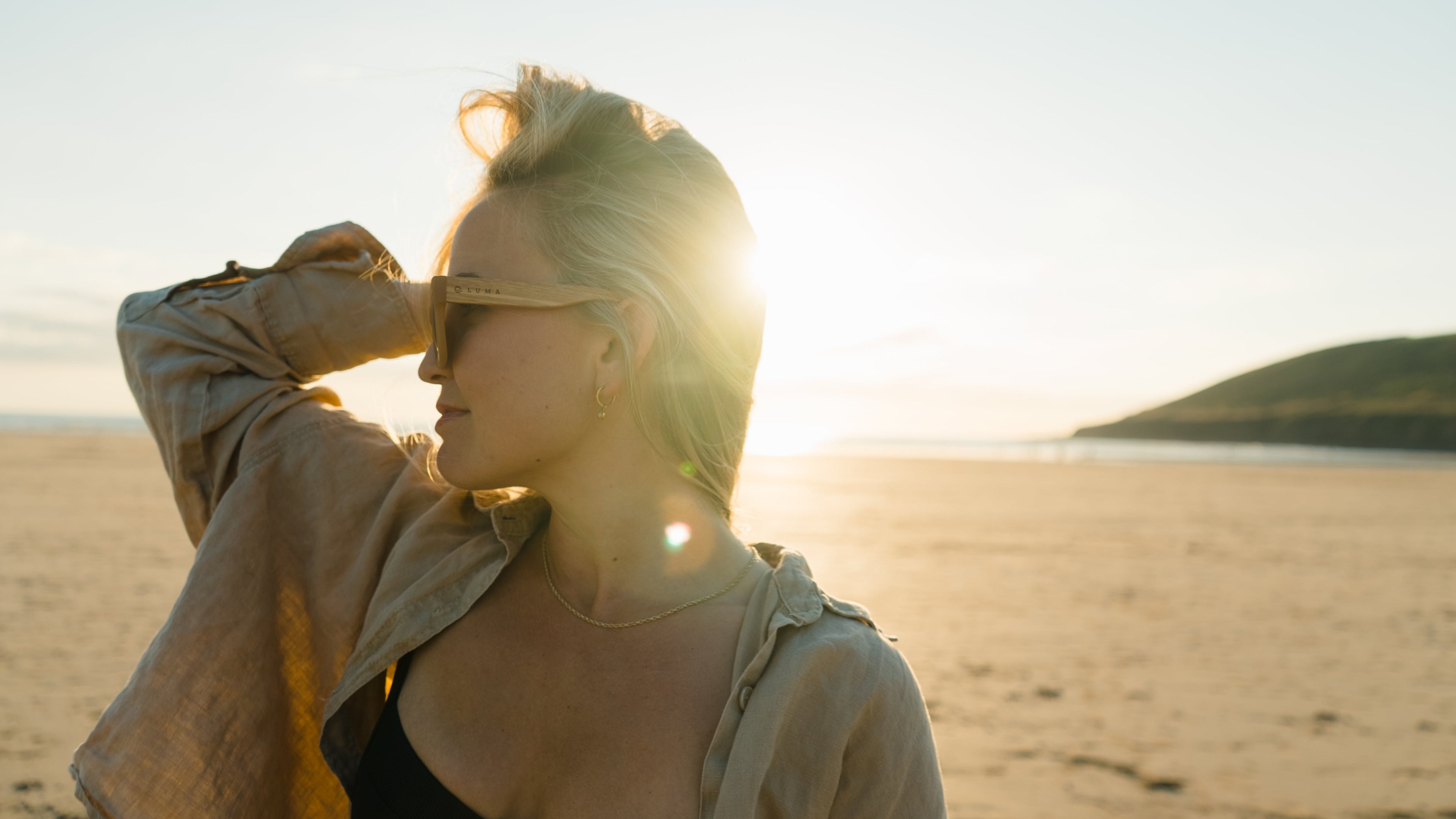 Lady wearing polzeath sunglasses on a beach