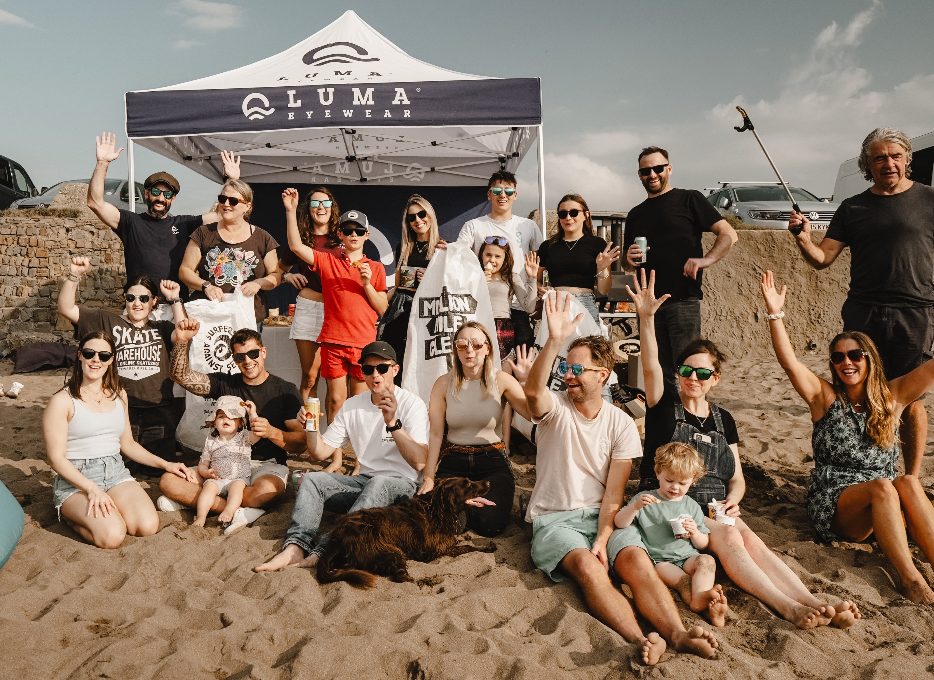 Large group of people celebrating on the beach after a beach litter pick