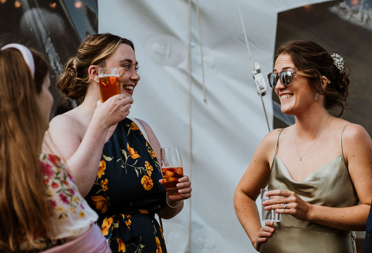 Bridesmaid in Devon drinking and laughing with guests 