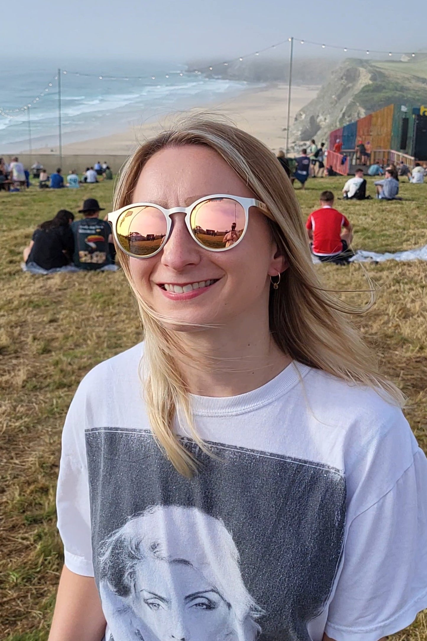 Lady smiling at the Boardmasters festival while wearing sunglasses 