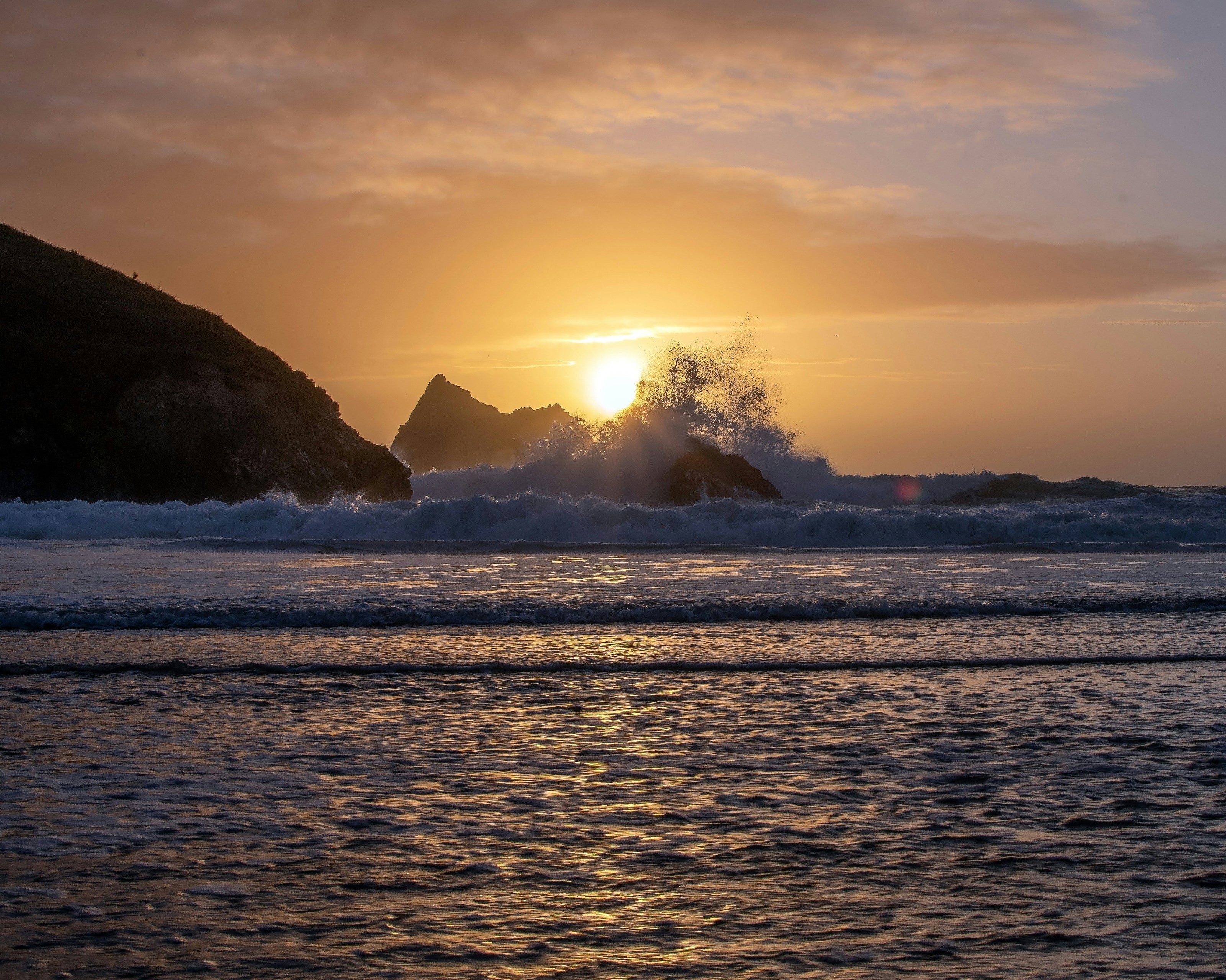 waves crashing at sunset Holywell bay