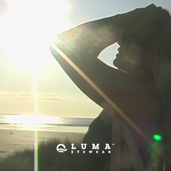 Model on beach at sunset wearing sustainable sunglasses